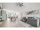 Spacious open concept living room featuring light wood floors and a ceiling fan at 18902 Spring Hollow Dr, Lutz, FL 33559