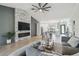 Cozy living room with open concept design, a modern fireplace, and stylish furnishings at 18902 Spring Hollow Dr, Lutz, FL 33559