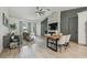 Open concept living room with vaulted ceilings, modern fireplace, and natural light at 18902 Spring Hollow Dr, Lutz, FL 33559