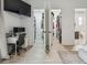 Bright office space adjacent to dual walk-in closets and bath features a built-in desk and wall-mounted television at 18902 Spring Hollow Dr, Lutz, FL 33559
