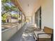 Wide screened porch with backyard access showing sliding glass doors, outdoor seating and storage shed at 18902 Spring Hollow Dr, Lutz, FL 33559