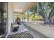 Spacious screened porch with backyard views featuring a playhouse and seating area at 18902 Spring Hollow Dr, Lutz, FL 33559