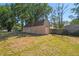 View of the large storage shed in the backyard with partial shade and a fully-fenced perimeter at 18902 Spring Hollow Dr, Lutz, FL 33559