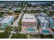 Aerial view of condo buildings with pool, hot tub, beach access, and coastal neighborhood at 1912 Gulf Blvd # 305, Indian Rocks Beach, FL 33785
