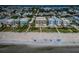 Coastal aerial of condos on a sandy beach with access path, waterfront, and coastal neighborhood at 1912 Gulf Blvd # 305, Indian Rocks Beach, FL 33785