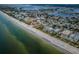 Beautiful coastal homes line the shore in this scenic aerial shot, complemented by the stunning gulf and clear skies at 1912 Gulf Blvd # 305, Indian Rocks Beach, FL 33785