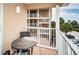 Balcony with table and chairs, showing view of parking area and other condo buildings at 1912 Gulf Blvd # 305, Indian Rocks Beach, FL 33785