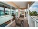 Balcony with wicker furniture; view extends to include living room through large, sliding glass doors at 1912 Gulf Blvd # 305, Indian Rocks Beach, FL 33785