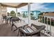 Balcony featuring wicker furniture, offering views of surrounding buildings and palm trees at 1912 Gulf Blvd # 305, Indian Rocks Beach, FL 33785