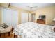 Comfortable bedroom features hardwood floors, a ceiling fan, chair and ample closet space at 1912 Gulf Blvd # 305, Indian Rocks Beach, FL 33785