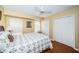 Comfortable bedroom features hardwood floors, a ceiling fan, window and ample closet space at 1912 Gulf Blvd # 305, Indian Rocks Beach, FL 33785