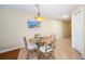 Charming dining room with seating for four, accented by a unique hanging light fixture and beach-themed decor at 1912 Gulf Blvd # 305, Indian Rocks Beach, FL 33785