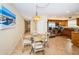 Cozy dining area with a glass table, seating for four, and tile flooring adjoining the kitchen at 1912 Gulf Blvd # 305, Indian Rocks Beach, FL 33785