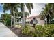 Attractive condo entrance with tropical landscaping and a welcoming sign for Oceanfront 1912 at 1912 Gulf Blvd # 305, Indian Rocks Beach, FL 33785