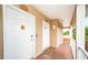 Hallway showing two entry doors to units with coded entry locks, a no smoking sign, and a view to an open-air balcony at 1912 Gulf Blvd # 305, Indian Rocks Beach, FL 33785