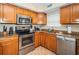 Modern kitchen with stainless steel appliances, a convenient dishwasher, and durable countertops for meal preparation at 1912 Gulf Blvd # 305, Indian Rocks Beach, FL 33785