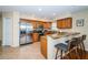 Well-equipped kitchen featuring stainless steel appliances, granite countertops, and a breakfast bar with seating at 1912 Gulf Blvd # 305, Indian Rocks Beach, FL 33785