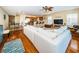 Spacious open living room with hardwood floors, ceiling fan, and open flow to kitchen and dining areas at 1912 Gulf Blvd # 305, Indian Rocks Beach, FL 33785