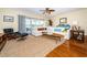 Bright living room with a plush sofa, stylish decor, ceiling fan and access to the balcony at 1912 Gulf Blvd # 305, Indian Rocks Beach, FL 33785