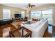 Inviting living room with hardwood floors, comfortable seating, a ceiling fan, and sliding glass doors to a balcony at 1912 Gulf Blvd # 305, Indian Rocks Beach, FL 33785