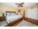Comfortable bedroom featuring hardwood floors, an ensuite bathroom, and natural light at 1912 Gulf Blvd # 305, Indian Rocks Beach, FL 33785