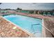 Inviting community pool with brick pavers and lounge chairs, perfect for relaxation near the beach at 1912 Gulf Blvd # 305, Indian Rocks Beach, FL 33785