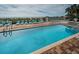 A beautiful pool and lounging area is surrounded by lush greenery at 1912 Gulf Blvd # 305, Indian Rocks Beach, FL 33785