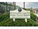 Sign for 20th Avenue Beach Access Park at Indian Rocks Beach with lush greenery in the foreground at 1912 Gulf Blvd # 305, Indian Rocks Beach, FL 33785
