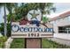 Attractive entryway sign with the name 'Oceanway' displayed among lush greenery and tropical palm trees at 1912 Gulf Blvd # 305, Indian Rocks Beach, FL 33785