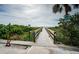 Charming boardwalk pathway leading to the beach, inviting a peaceful stroll amidst lush coastal vegetation at 1912 Gulf Blvd # 305, Indian Rocks Beach, FL 33785