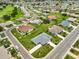 An aerial view of a suburban community featuring well-kept lawns, paved roads, and tidy landscaping at 1915 W Del Webb Blvd, Sun City Center, FL 33573