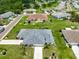 Bird's-eye view of a home showcasing a well-manicured lawn and garden beds, nestled in a quiet neighborhood at 1915 W Del Webb Blvd, Sun City Center, FL 33573