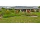 Beautifully landscaped backyard featuring lush greenery and a colorful garden, creating a serene outdoor space at 1915 W Del Webb Blvd, Sun City Center, FL 33573