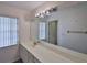 Bathroom features a long vanity with a sink and large mirror at 1915 W Del Webb Blvd, Sun City Center, FL 33573