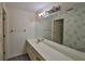 Bathroom features long vanity with large mirror and updated lighting at 1915 W Del Webb Blvd, Sun City Center, FL 33573