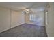 Empty bedroom with carpet, a ceiling fan, and a window at 1915 W Del Webb Blvd, Sun City Center, FL 33573