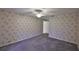 Empty bedroom with carpet, a ceiling fan, and wallpaper at 1915 W Del Webb Blvd, Sun City Center, FL 33573