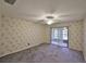 Carpeted bedroom with ceiling fan and sliding glass doors to porch at 1915 W Del Webb Blvd, Sun City Center, FL 33573