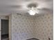 Bedroom featuring patterned wallpaper and ceiling fan with light at 1915 W Del Webb Blvd, Sun City Center, FL 33573