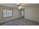 Empty bedroom with carpet, a ceiling fan, and natural light at 1915 W Del Webb Blvd, Sun City Center, FL 33573