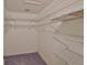 Well-organized walk-in closet with white wire shelving and carpeted floor at 1915 W Del Webb Blvd, Sun City Center, FL 33573