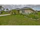Lovely single-story home featuring lush greenery and charming landscaping at 1915 W Del Webb Blvd, Sun City Center, FL 33573