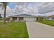 Beautiful single-story home featuring a lush green lawn and well-maintained landscaping at 1915 W Del Webb Blvd, Sun City Center, FL 33573