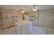 Bright kitchen features an island, plenty of cabinets, and white appliances at 1915 W Del Webb Blvd, Sun City Center, FL 33573