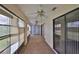 Enclosed porch featuring multiple ceiling fans and sliding glass doors at 1915 W Del Webb Blvd, Sun City Center, FL 33573