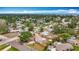 An aerial view shows the neighborhood with lush greenery and well-maintained homes near the ocean at 200 Lewis Se Blvd, St Petersburg, FL 33705