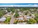 An aerial view shows the neighborhood with lush greenery, quiet streets, and distant city skyline at 200 Lewis Se Blvd, St Petersburg, FL 33705