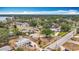 An aerial view of a quiet, green neighborhood with houses, shady trees, and a fenced-in yard at 200 Lewis Se Blvd, St Petersburg, FL 33705