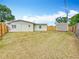 A spacious backyard enclosed with a wooden fence that provides a private area for outdoor activities at 200 Lewis Se Blvd, St Petersburg, FL 33705