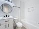 Bathroom featuring a vanity, a toilet, and a tub with a tiled surround at 200 Lewis Se Blvd, St Petersburg, FL 33705